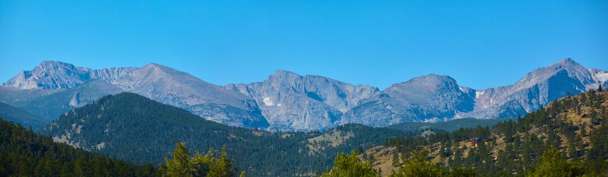 Image of Panorama of large mountain range with hills of pine trees