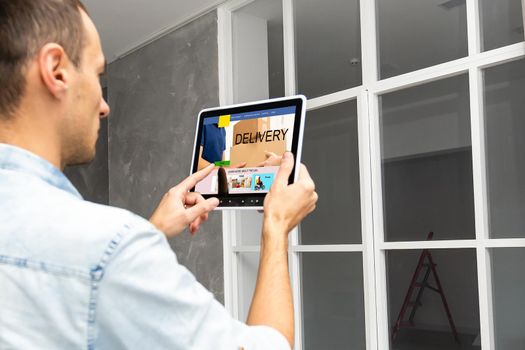 Male hands with tablet, closeup. World map with delivery network on screen. Logistics concept