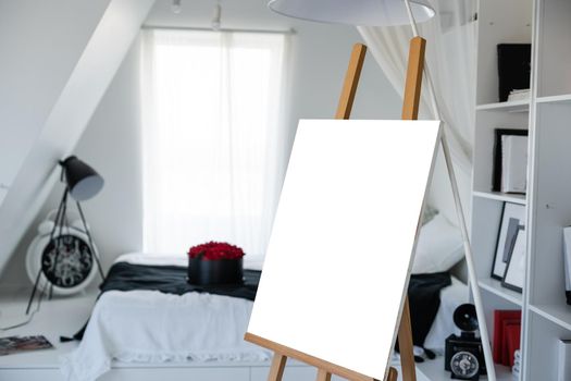 Easel with painting in artist's workshop.