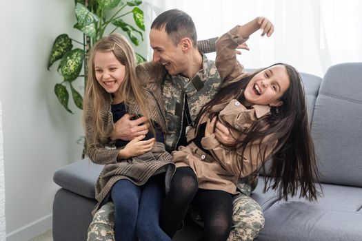 Happy military father holding daughter. family, bonding and patriotism,