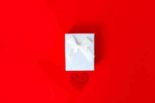 Gift box on red background. Romantic st. Valentine's day concept of greetings. place for your text.