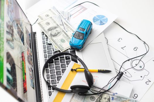 toy car with dollars is on the laptop. The programmer.