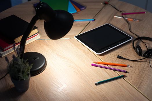 Student desk top view, teenager home workplace table with studying stationery tablet, textbooks.