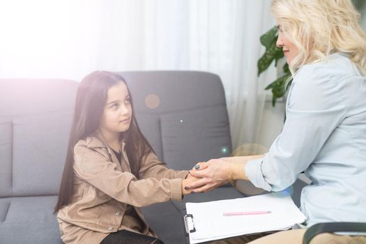 Young child psychologist working with little girl.