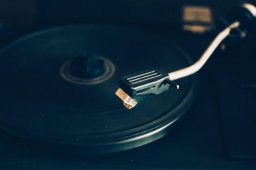 Vinyl record player on a sunset background over the city lights. Sound technology for DJs to mix and play music. Black vinyl record. 1980 vintage vinyl wood record player. Vinyl record needle