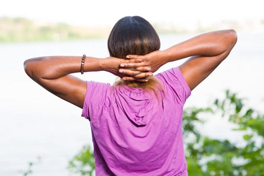 happy and free woman with open arms after fitness, enjoying the view with arms crossed over her head