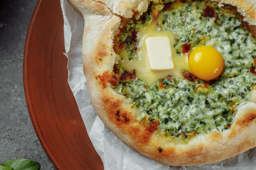 Some khachapuri traditional Georgian homemade cheese and spinach pies on the plate.