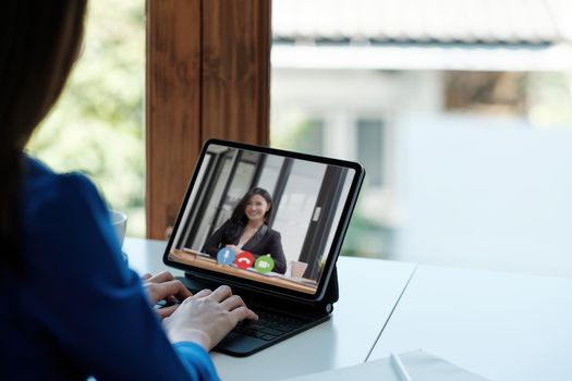 App for communication with employees. Online video conference. woman communicates via video call with business partners, he sits at the creative modern office space