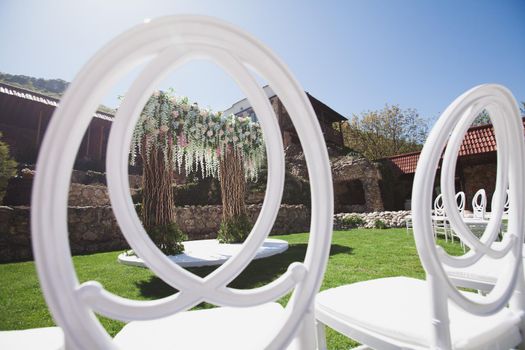 White chairs for guests at the wedding ceremony