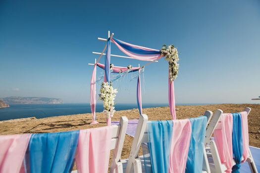 Wedding arch pink color on the background of the sea.