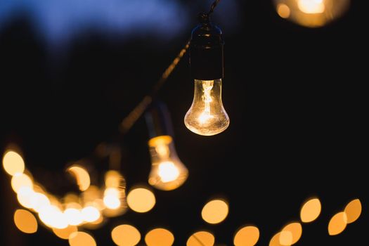 outdoor string lights hanging on a line in backyard