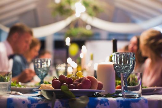 Guests eat at the wedding table. Table close-up