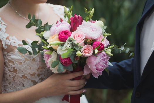 bouquet of flowers in the hands of the bride