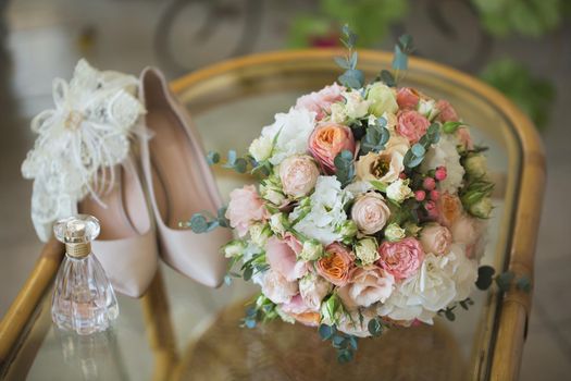 Wedding shoes with bouquet of flowers and perfume