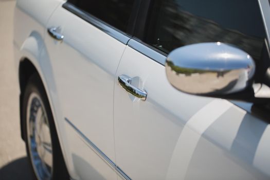 White Car with Silver Car Door Handle