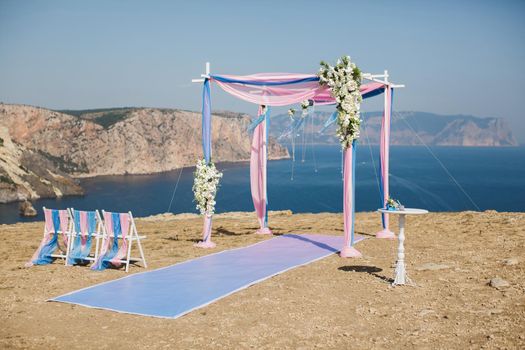 Wedding arch pink color on the background of the sea.