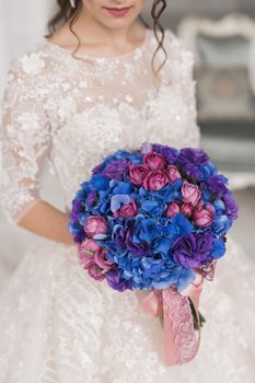 Close-up of a bouquet of flowers in the hands of the bride.