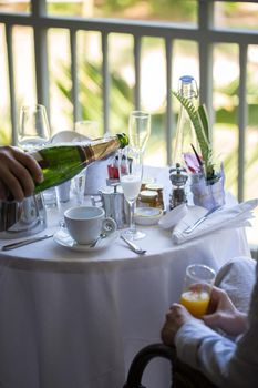 A man pours champagne in a glass