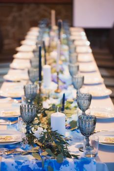 Wedding banquet. Table setting with blue glasses