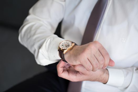 A man puts a watch on his hand