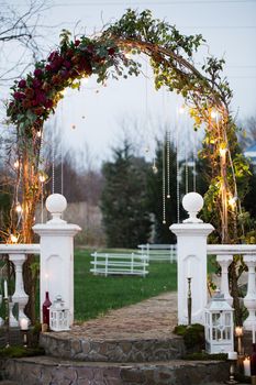 Wedding arch in an ancient park at sunset