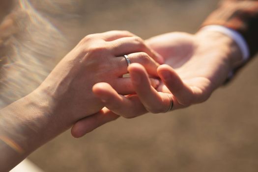 Hands of the bride and groom close up