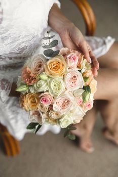 Close-up of a bouquet of flowers in the hands of the bride.