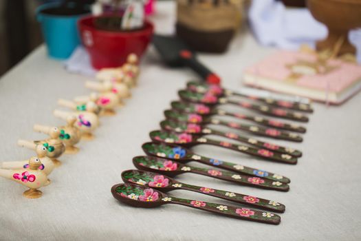 Wooden spoons with floral ornaments and whistles in the national style.