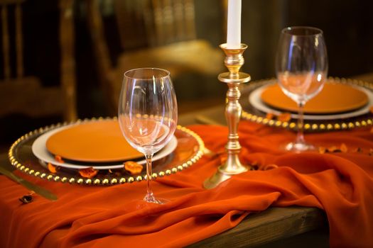 Table setting in the restaurant: flowers, candles and dishes.