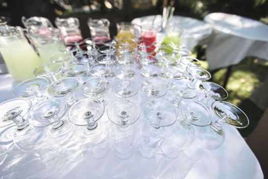 Set of blank empty wine glasses displayed in rows. Preparation for the holiday