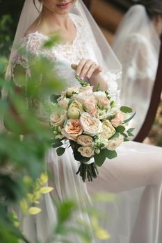 Close-up of a bouquet of flowers in the hands of the bride.