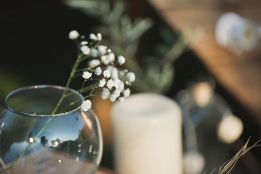 Wedding decor made of candles, wooden boxes and gypsophila