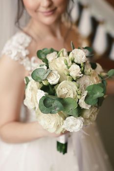 Close-up of a bouquet of flowers in the hands of the bride.