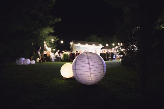 Decor of airy Japanese lanterns at a wedding.