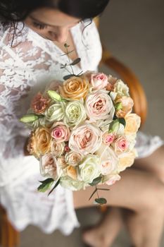 Close-up of a bouquet of flowers in the hands of the bride.