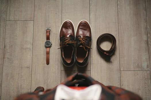 Stylish men's plaid suit and brown shoes, watch and groom's belt