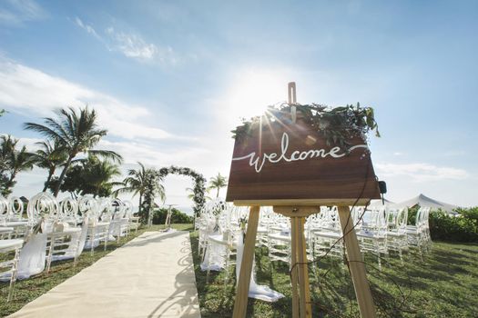 Romantic wedding ceremony on the beach. Sign welcome