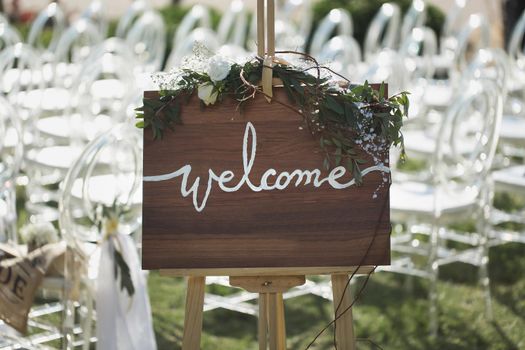 Romantic wedding ceremony on the beach. Sign welcome