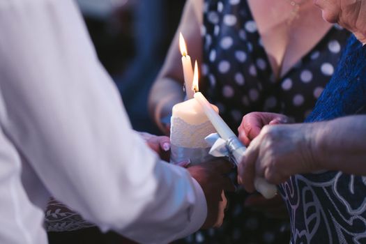 Wedding ceremony, paraphernalia, the bride and groom hold a large candle in their hand