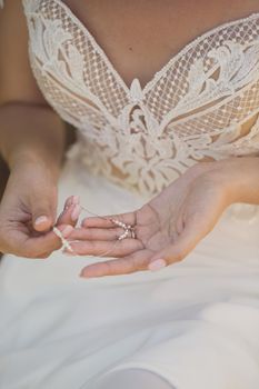 The bride is holding an ornament in her hands.