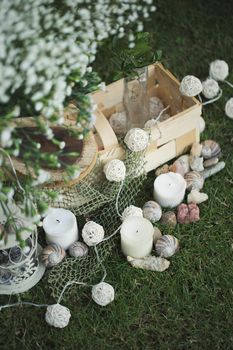 Rustic wedding decor: candles, flowers and a basket.
