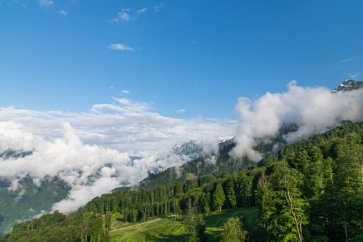 Caucasus mountains with trees and a clouds, Russia