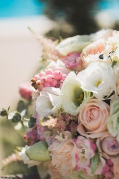 A luxurious delicate wedding bouquet of roses and eustom close-up.