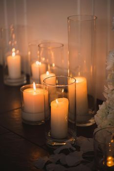 vases with candles stand for wedding ceremony