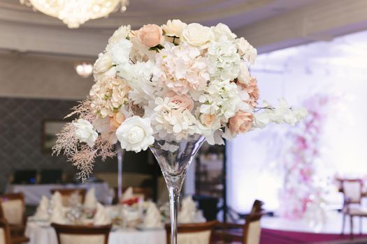 Table setting at a luxury wedding reception. Beautiful flowers on the table.