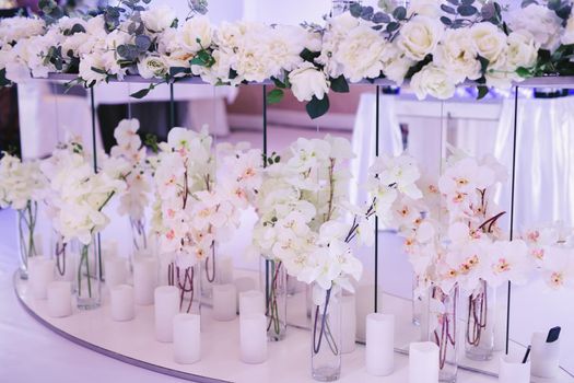Beautiful wedding decor: orchid flowers and candles.