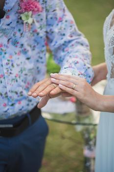 Wedding rings on the hands of newlyweds