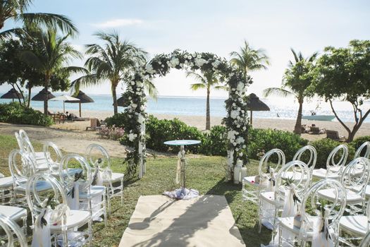 Romantic wedding ceremony on the beach near the ocean.
