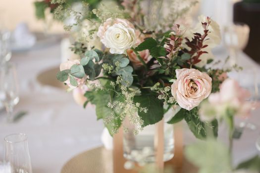 Table setting at a luxury wedding reception. Beautiful flowers on the table.