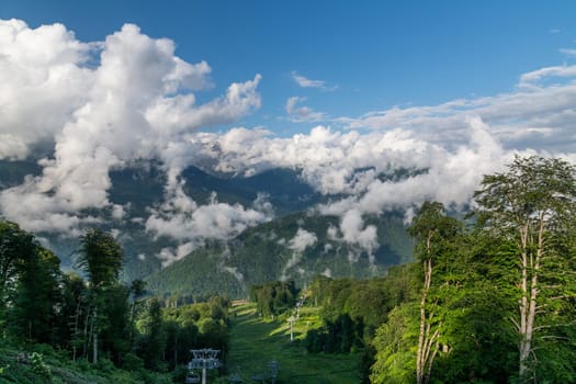 Caucasus mountains with trees and a clouds, Russia